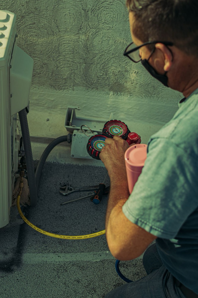 Coldway Comforts AC service technician checking cooling pressure